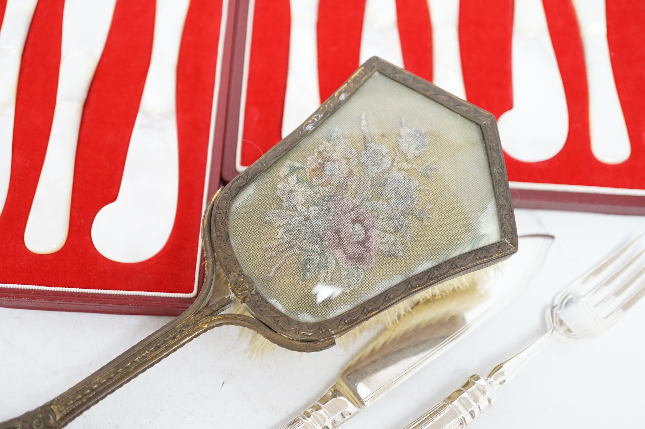 A quantity of plated ware including twelve pairs of fish eaters, a pair of sugar casters etc., together with two cased sets of six Asprey & Co mother of pearl butter knives. Condition - poor to fair to good